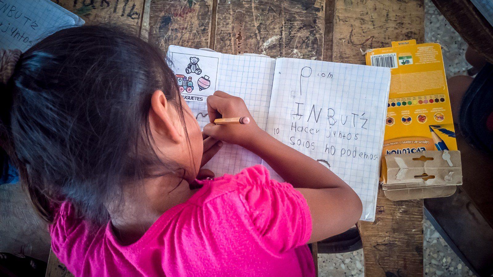 Niña escribiendo en su cuaderno en Guatemala